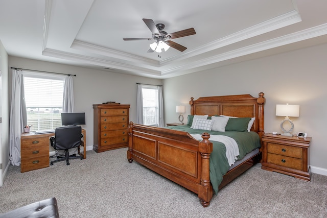 bedroom featuring carpet floors, a ceiling fan, baseboards, a tray ceiling, and crown molding