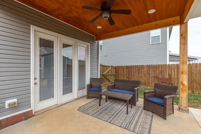 view of patio with ceiling fan, fence, and an outdoor living space