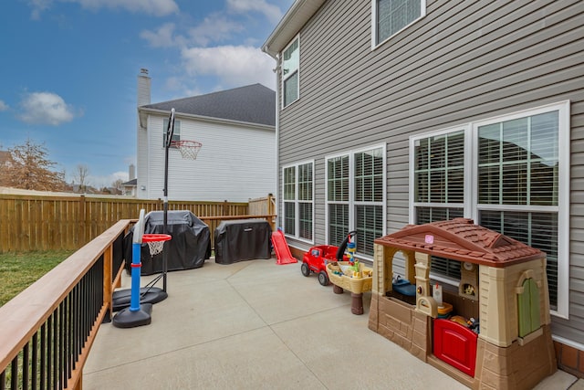 view of patio with fence and area for grilling