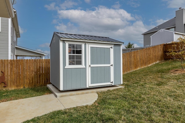 view of shed with a fenced backyard