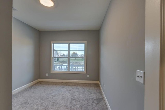 carpeted empty room featuring visible vents and baseboards