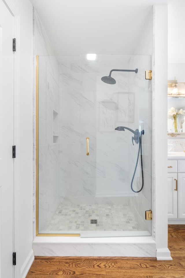 1775 Irvine Rd, Winchester, KY 40391 - full bathroom featuring a shower stall, a garden tub, wood finished floors, and two vanities