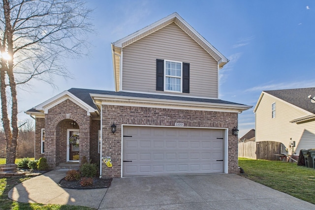 traditional-style home featuring a front yard, fence, concrete driveway, a garage, and brick siding