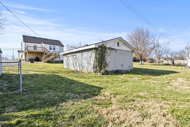 view of yard featuring stairway, an outbuilding, and fence