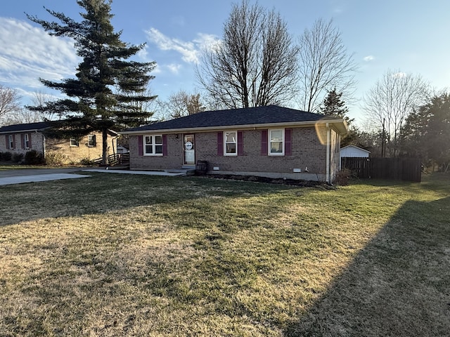 ranch-style house featuring crawl space, brick siding, fence, and a front lawn