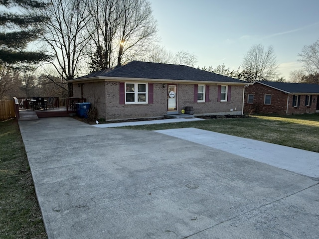 single story home featuring brick siding and a front yard