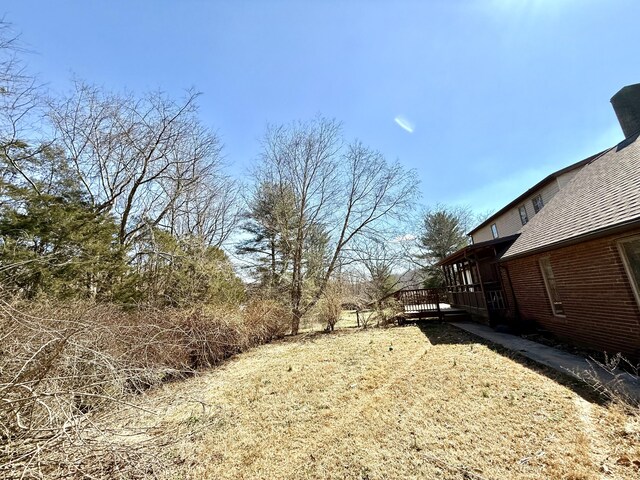 view of yard with a wooden deck