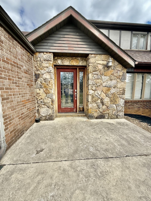 property entrance with stone siding