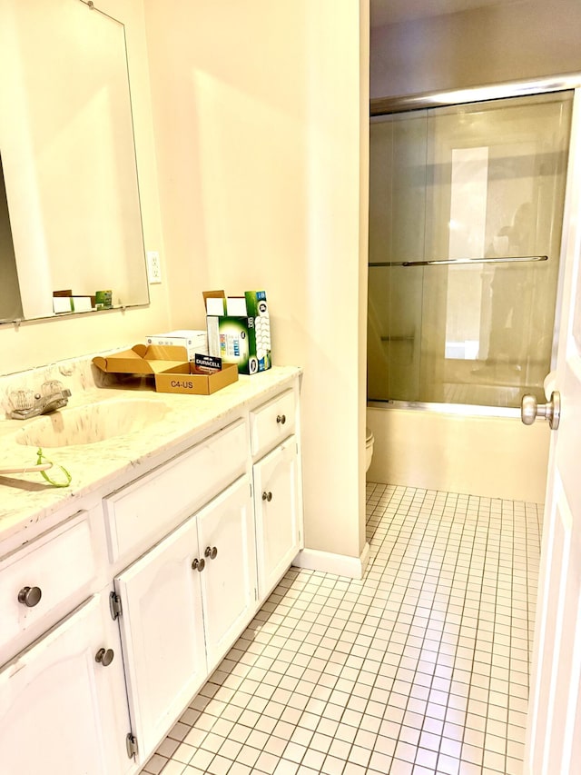 full bath with toilet, tile patterned flooring, combined bath / shower with glass door, and vanity