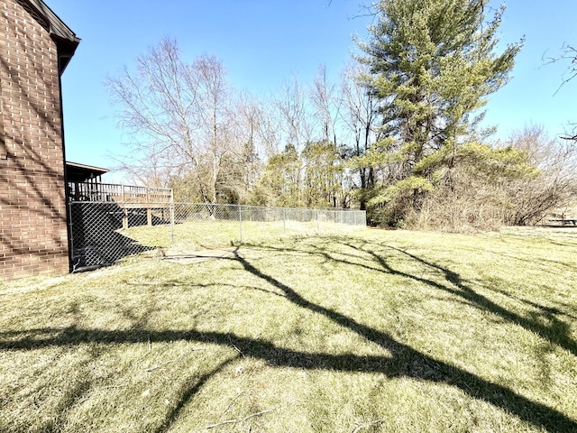 view of yard with fence and a wooden deck