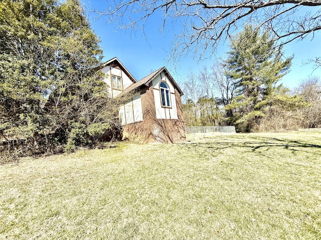 view of home's exterior with a yard