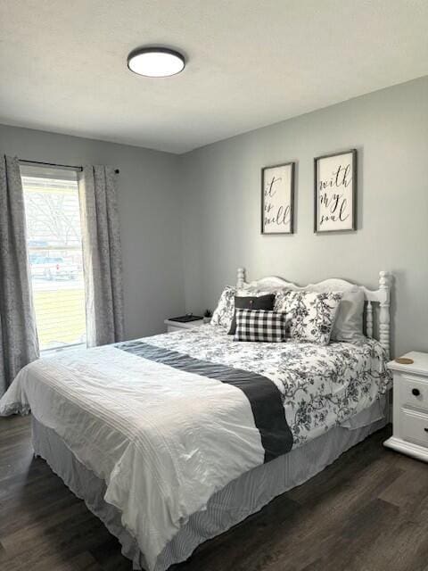 bedroom with dark wood-style flooring