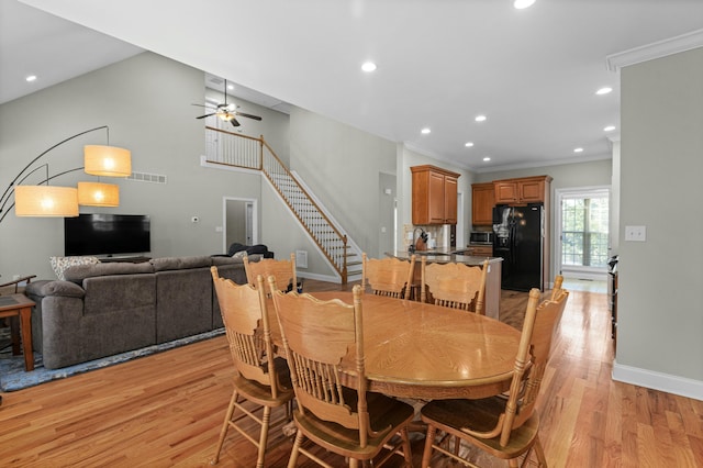 dining space featuring ornamental molding, recessed lighting, stairway, light wood finished floors, and baseboards