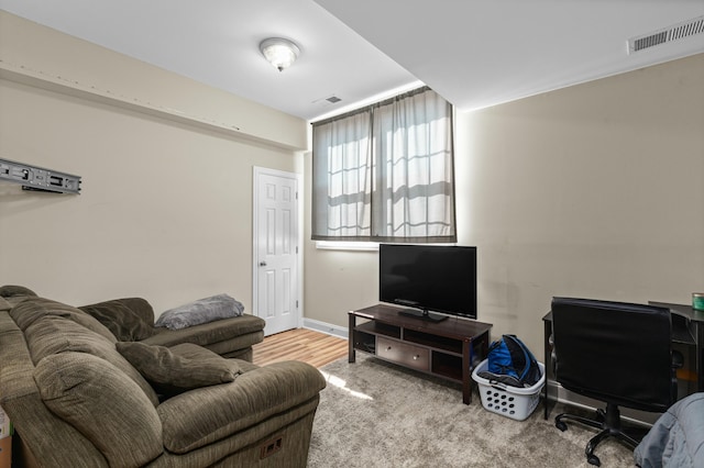 living room with visible vents and baseboards