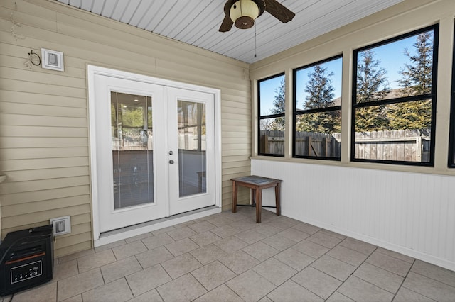 unfurnished sunroom with french doors and ceiling fan