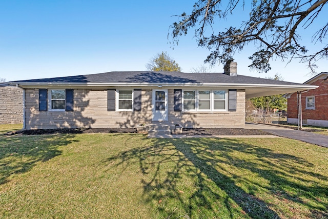 ranch-style home featuring an attached carport, driveway, a chimney, and a front yard