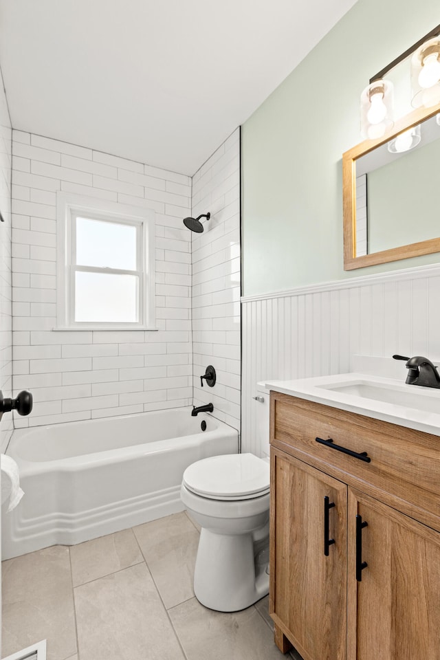 bathroom featuring a wainscoted wall, toilet, shower / bathing tub combination, tile patterned floors, and vanity