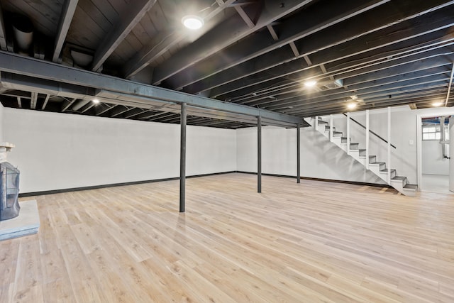 finished basement featuring wood finished floors and stairs