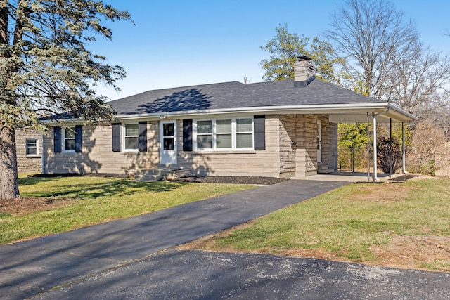 ranch-style home featuring a front yard, stone siding, driveway, and roof with shingles