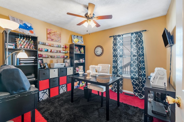 office area featuring baseboards, visible vents, ceiling fan, a textured ceiling, and carpet flooring