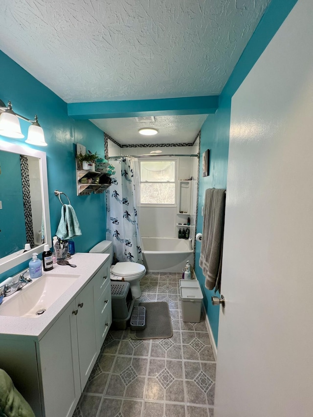 full bath featuring vanity, tile patterned flooring, shower / tub combo, a textured ceiling, and toilet