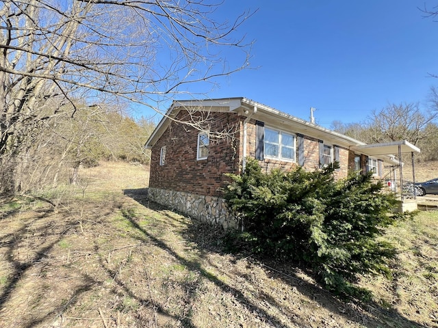 view of side of property featuring brick siding