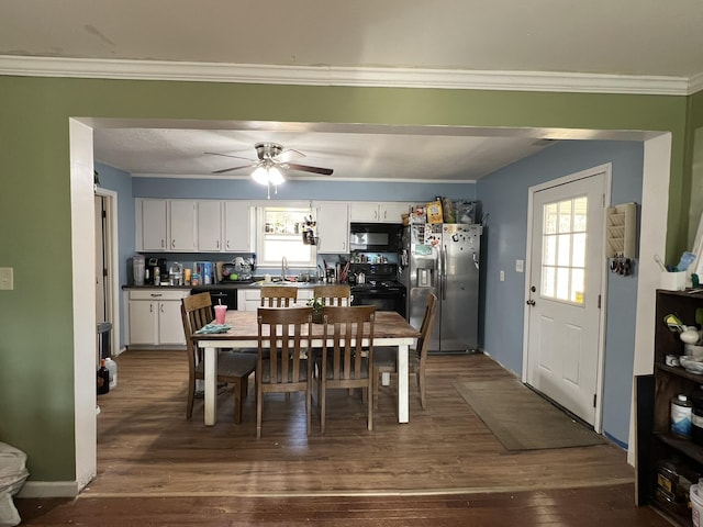 dining room featuring a ceiling fan, dark wood finished floors, and crown molding