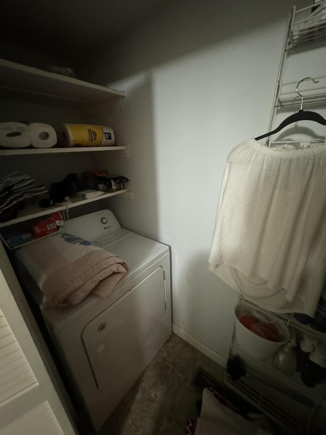 washroom featuring washer / clothes dryer, laundry area, and baseboards