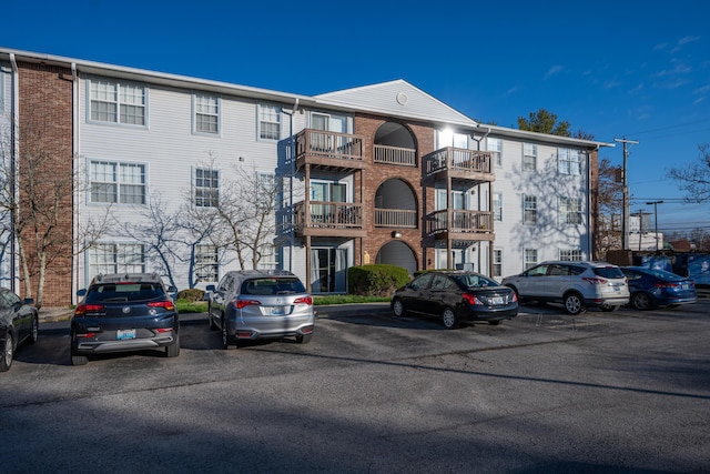 view of building exterior with uncovered parking