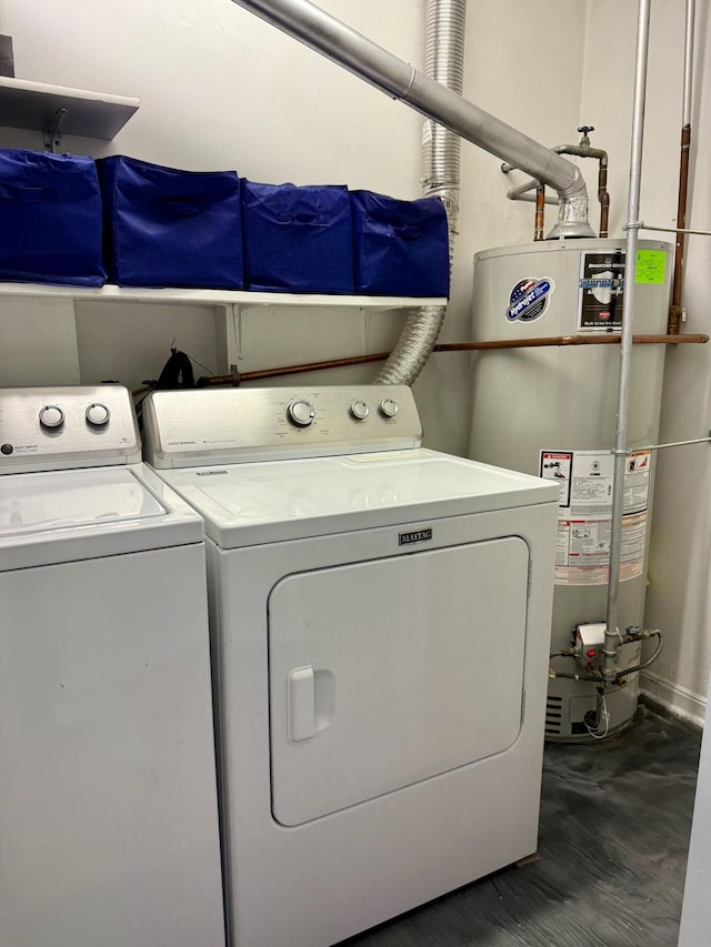 laundry area featuring wood finished floors, laundry area, water heater, and separate washer and dryer