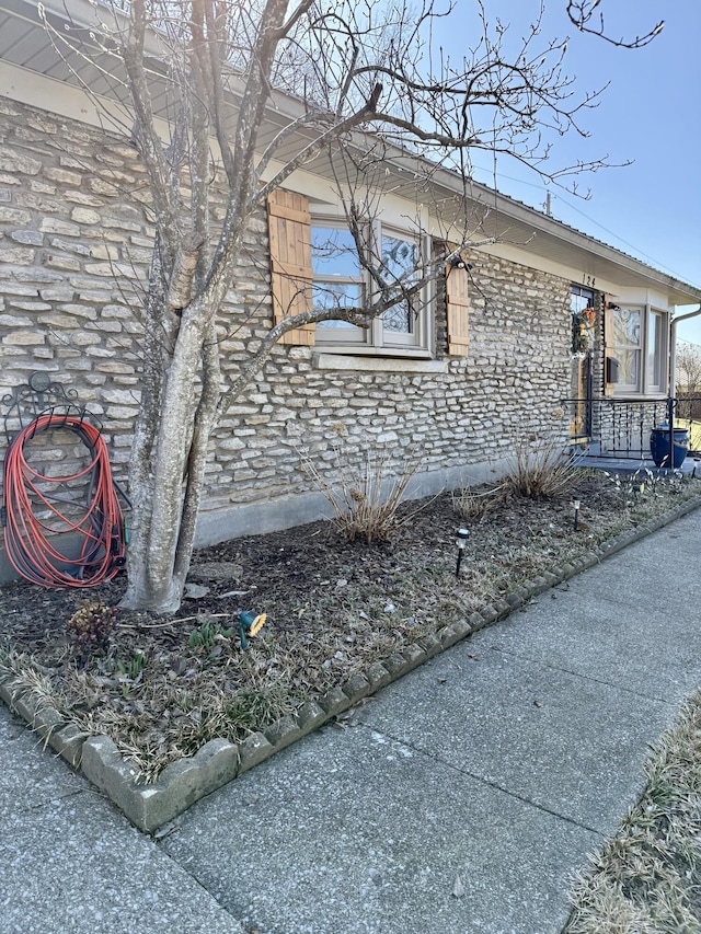 view of side of home featuring stone siding