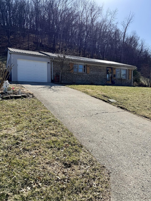 view of front facade featuring aphalt driveway, a front yard, and brick siding