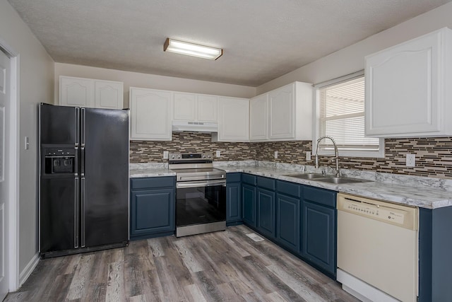 kitchen featuring blue cabinetry, white dishwasher, a sink, electric stove, and black fridge