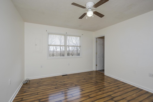 unfurnished room with visible vents, dark wood-type flooring, baseboards, a textured ceiling, and a ceiling fan