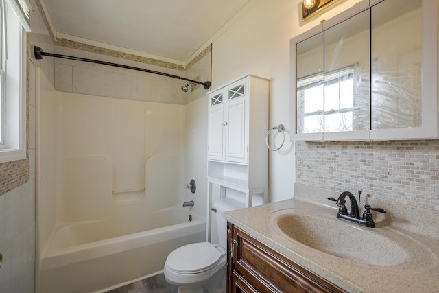 bathroom featuring decorative backsplash, toilet, bathtub / shower combination, and vanity