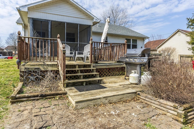 rear view of house with a deck and a sunroom