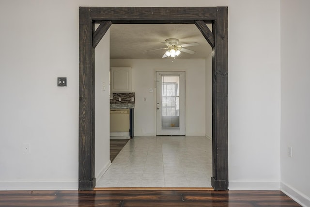 corridor with wood finished floors and baseboards