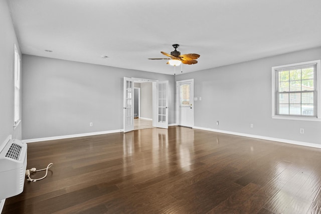 spare room featuring french doors, baseboards, and wood finished floors