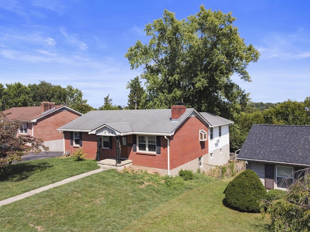 single story home featuring a front lawn, aphalt driveway, a shingled roof, brick siding, and a chimney