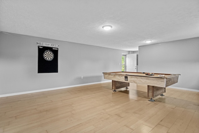 playroom with baseboards, light wood-style floors, billiards, and a textured ceiling