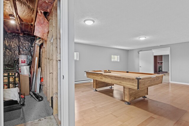 recreation room featuring baseboard heating, wood finished floors, billiards, and a textured ceiling