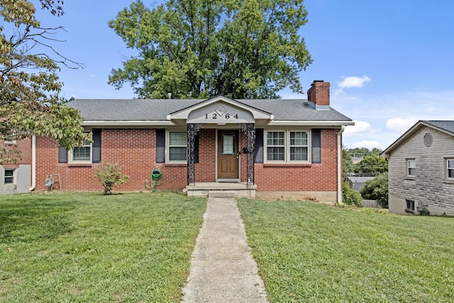 view of front of house with brick siding, a chimney, a front lawn, and a shingled roof