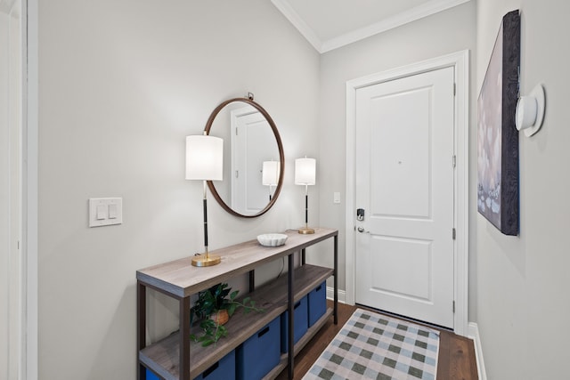 foyer with dark wood-style floors, baseboards, and ornamental molding