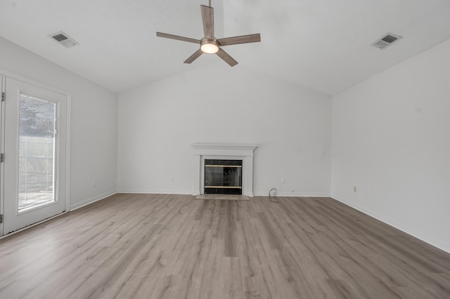 unfurnished living room featuring visible vents, light wood-style flooring, a ceiling fan, and a fireplace with flush hearth