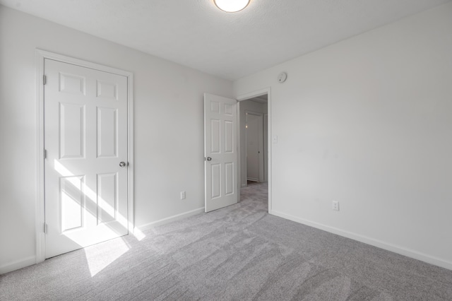 unfurnished bedroom featuring baseboards and carpet floors