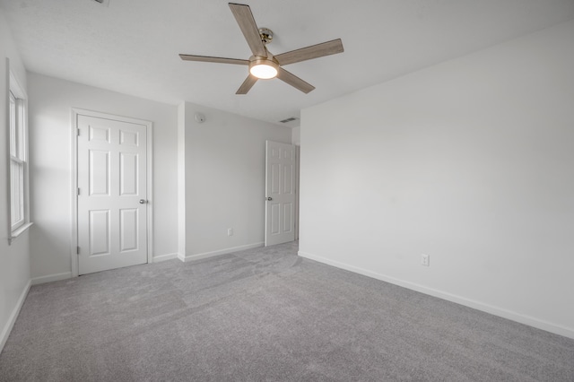 unfurnished bedroom featuring a ceiling fan, baseboards, and carpet floors