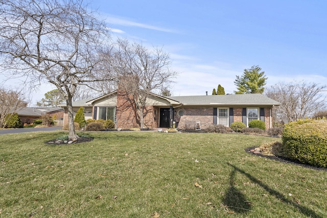 ranch-style house featuring a front yard and brick siding