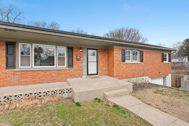 ranch-style house with an attached garage and brick siding