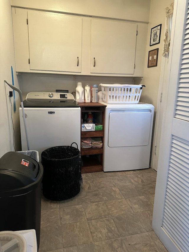 washroom featuring cabinet space and separate washer and dryer