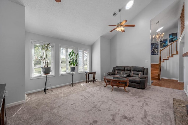 living room with baseboards, visible vents, carpet floors, ceiling fan, and a textured ceiling